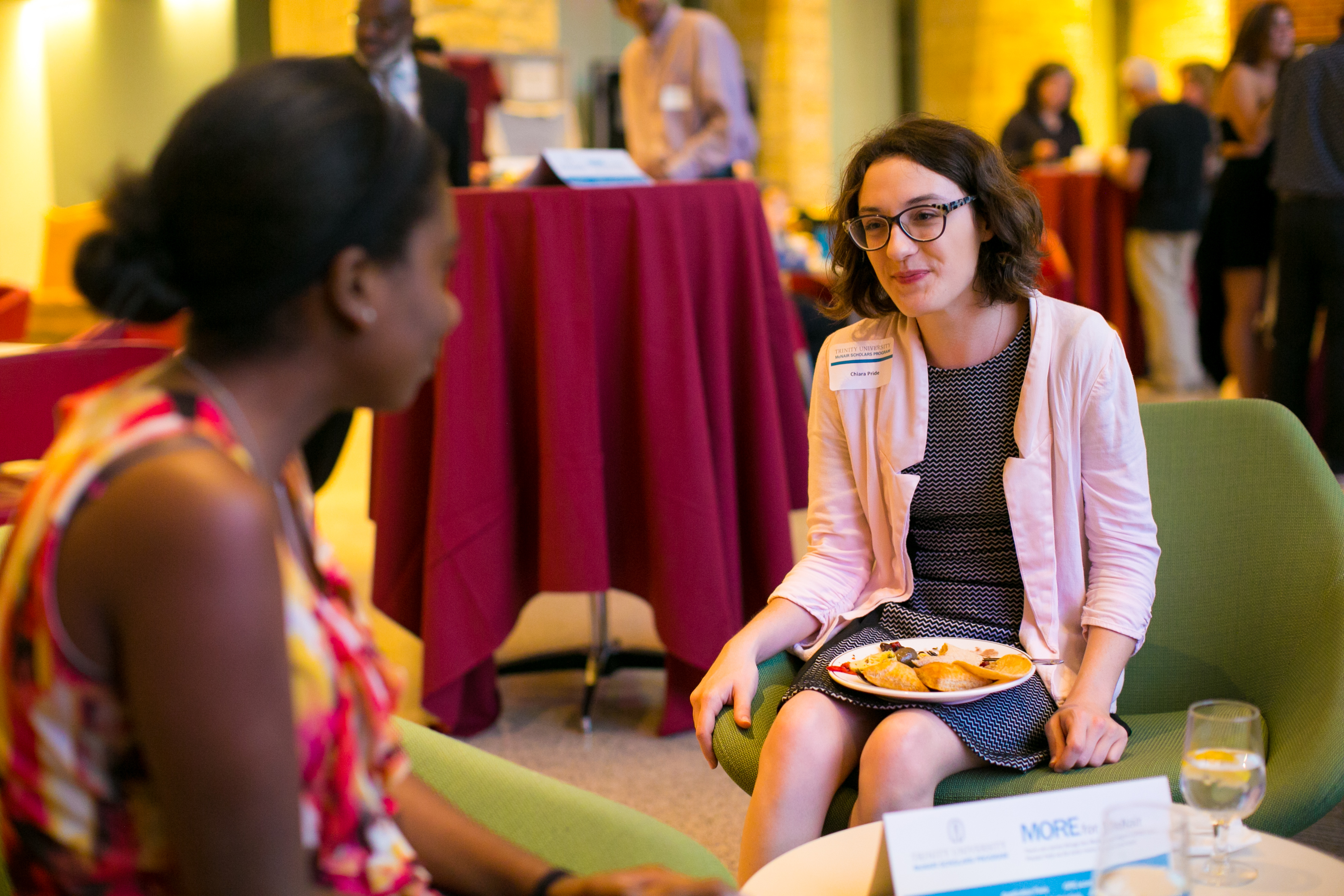 two women talking while eating