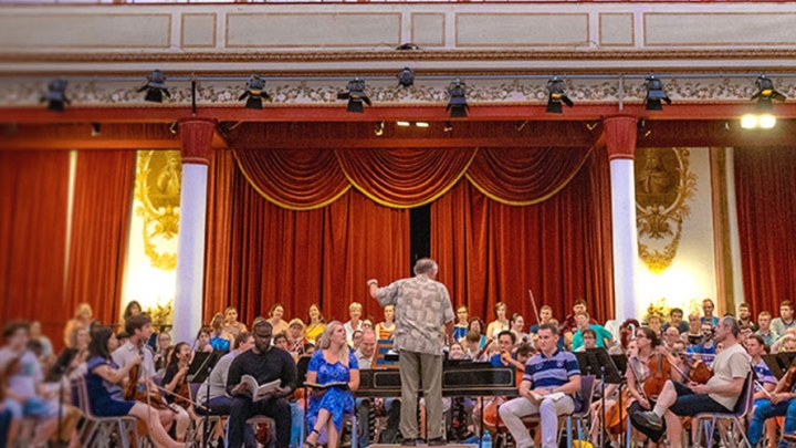 Professor conducts the Trinity orchestra during a performance. 