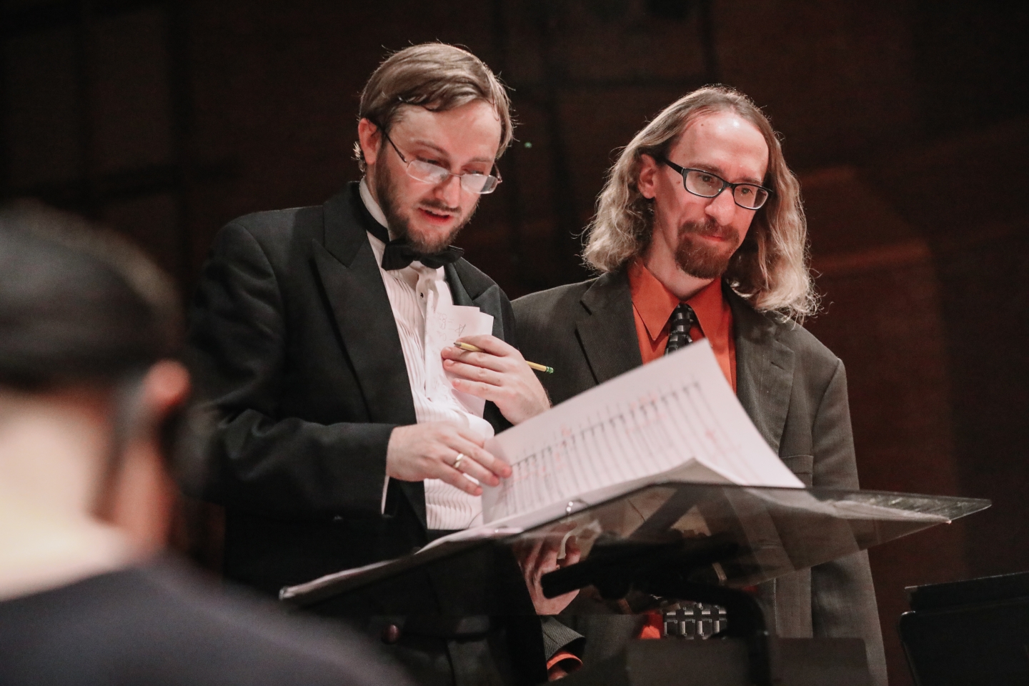 Two conductors reading music