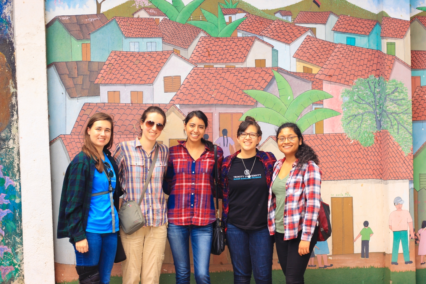 students in front of a mural