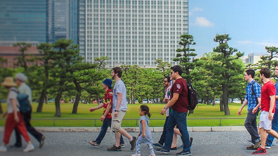 Trinity students walk together down a street.
