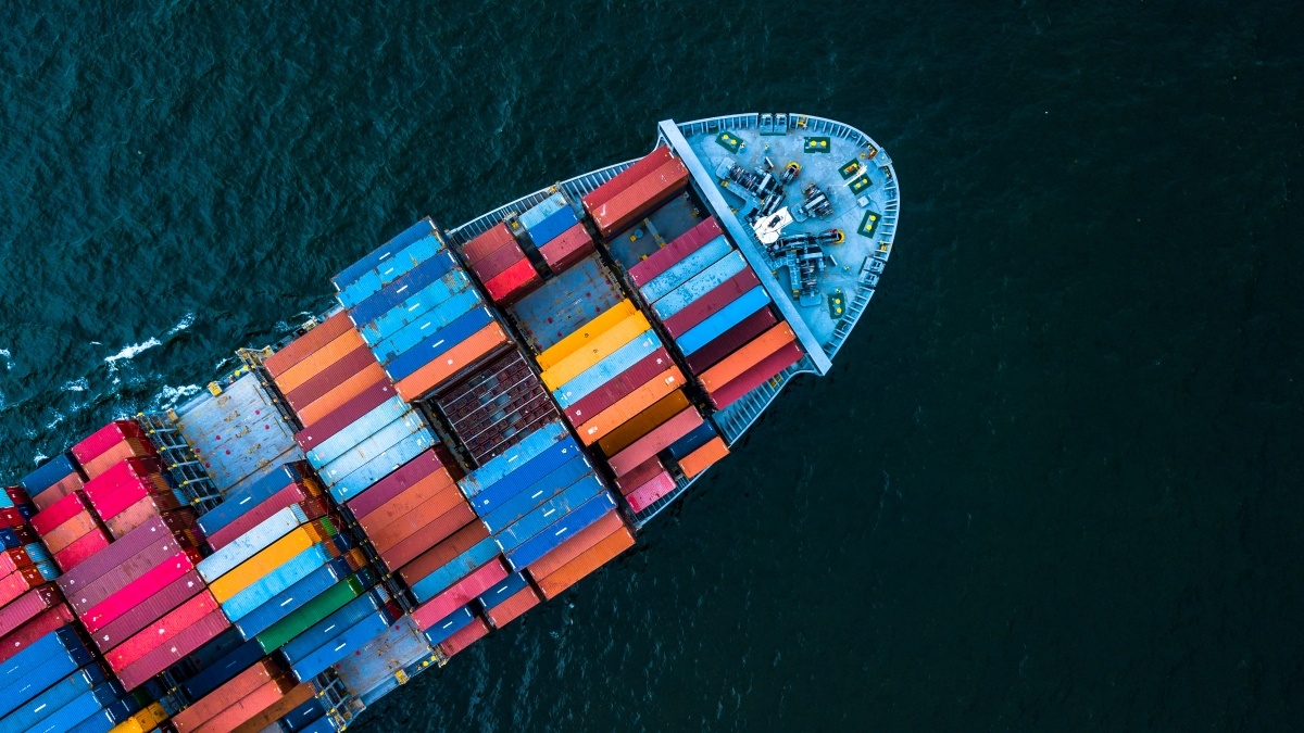 Top down view of container ship carrying cargo on the ocean