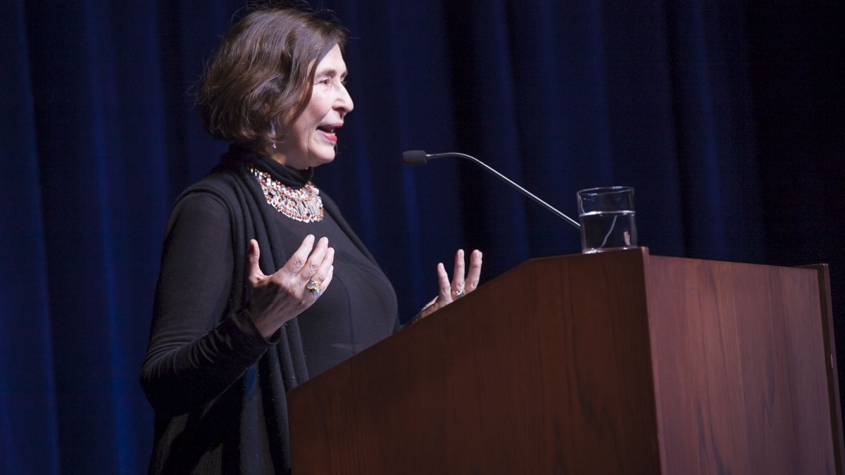 Female giving a lecture at a podium