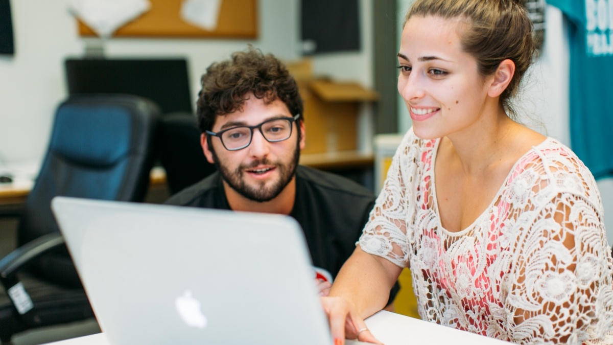 Two students looking at a computer screen