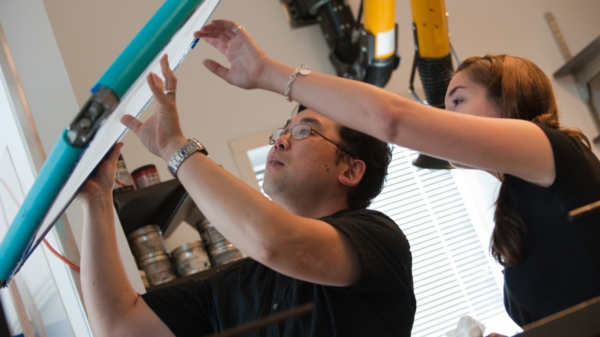 People Looking up at a Light Box