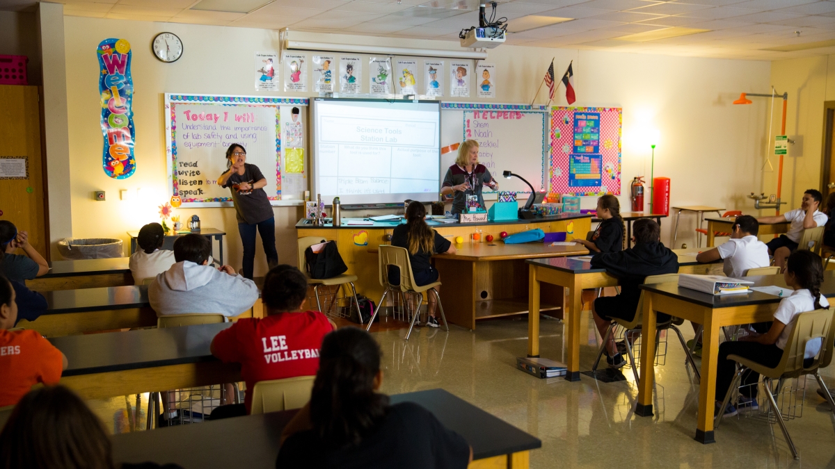 View from back of classroom as Trinity student presents to elementary classroom