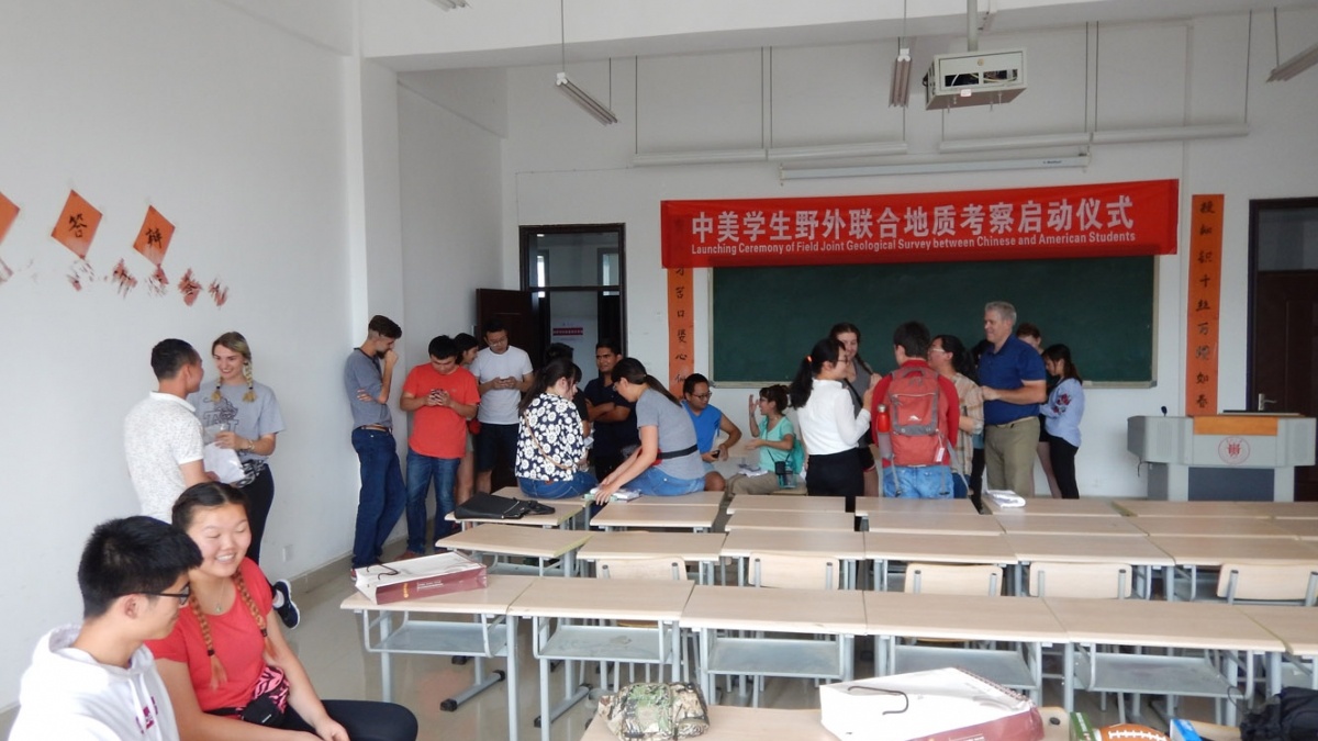 Trinity students gather with Chinese students in a classroom while studying in China