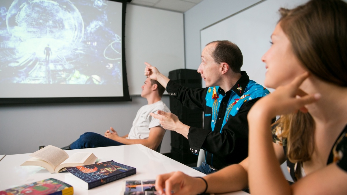 Group of students and professor walking through presentation
