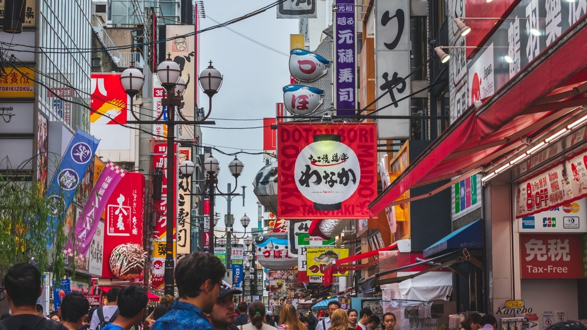A street in a chinese city is covered in promotional signage