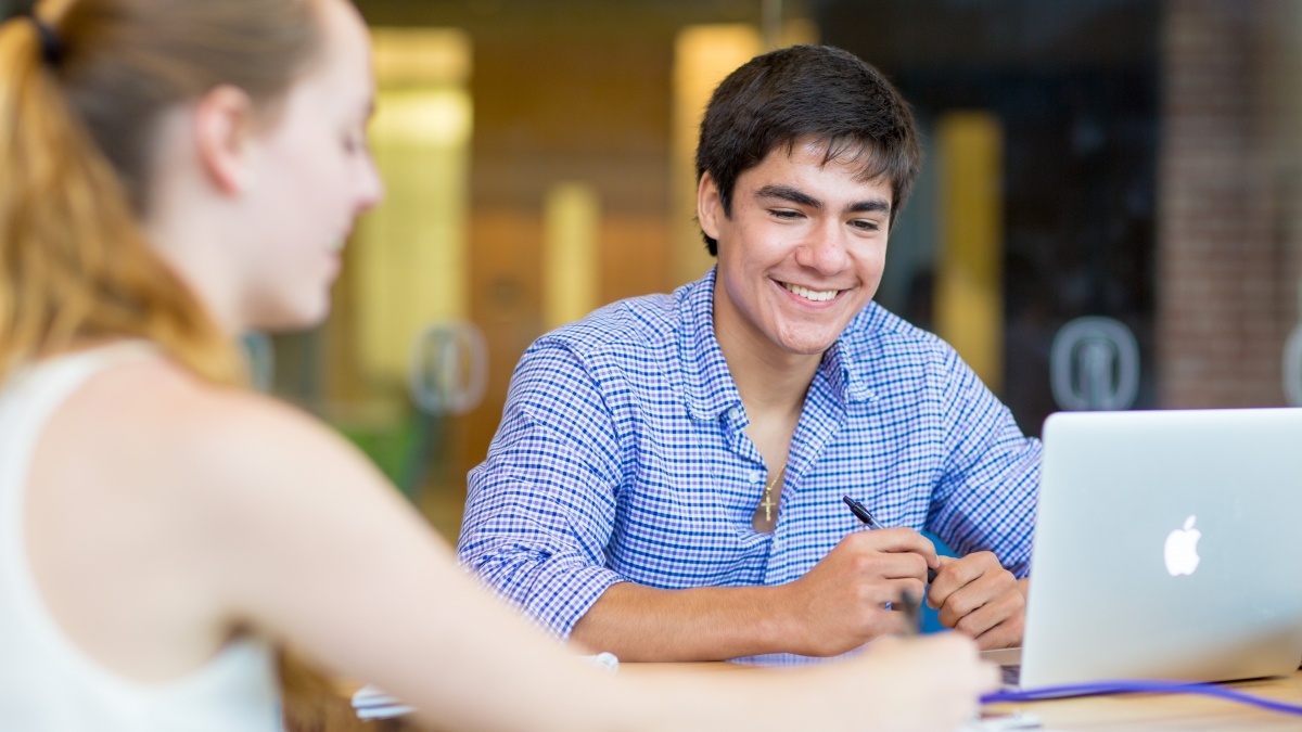 Two students studying with laptop.