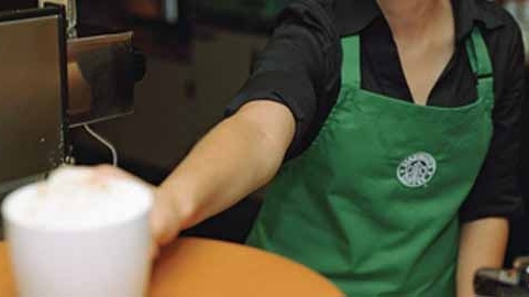 Worker serving coffee